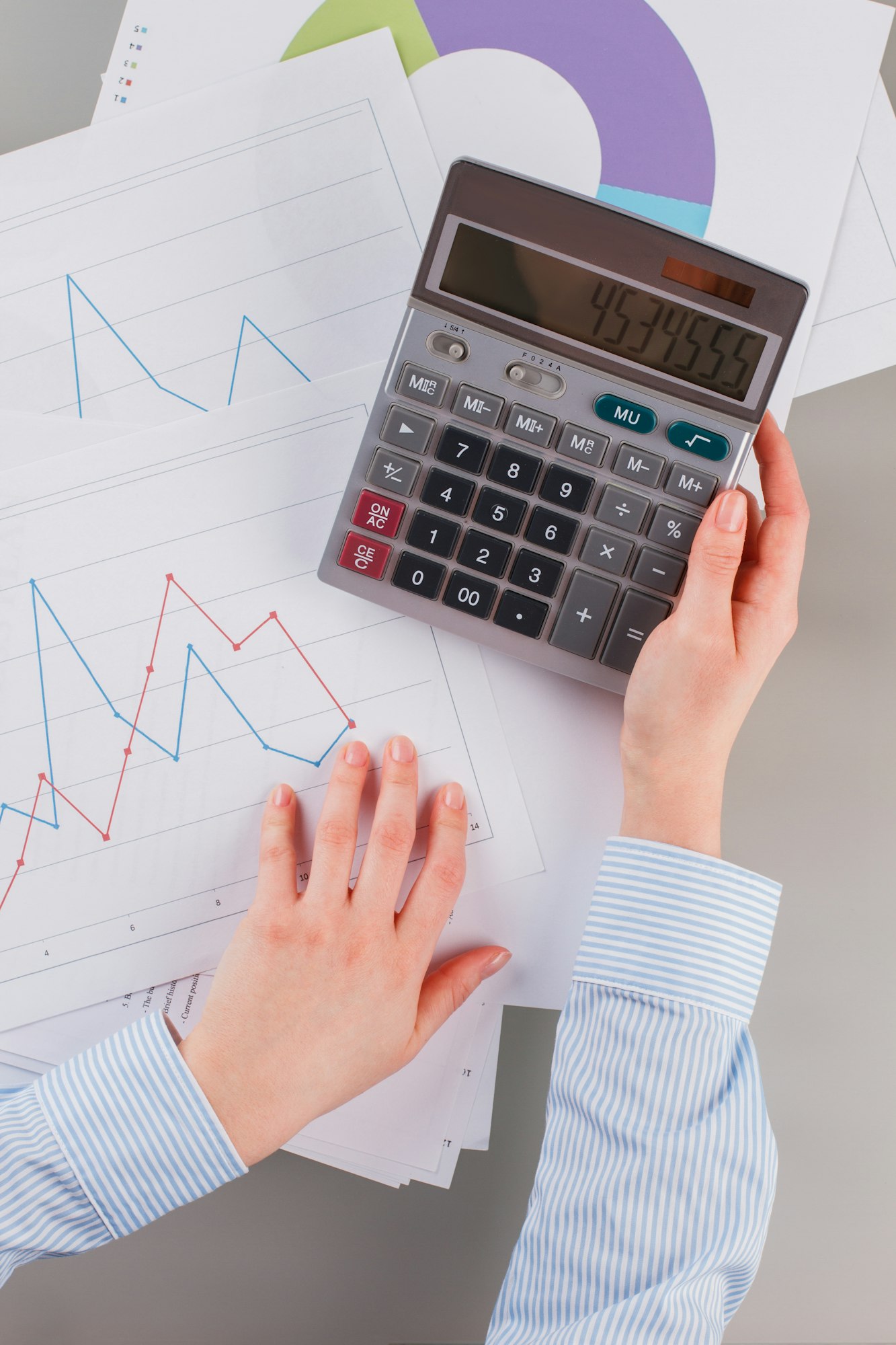 Top view businesswoman or accountant using calculator.