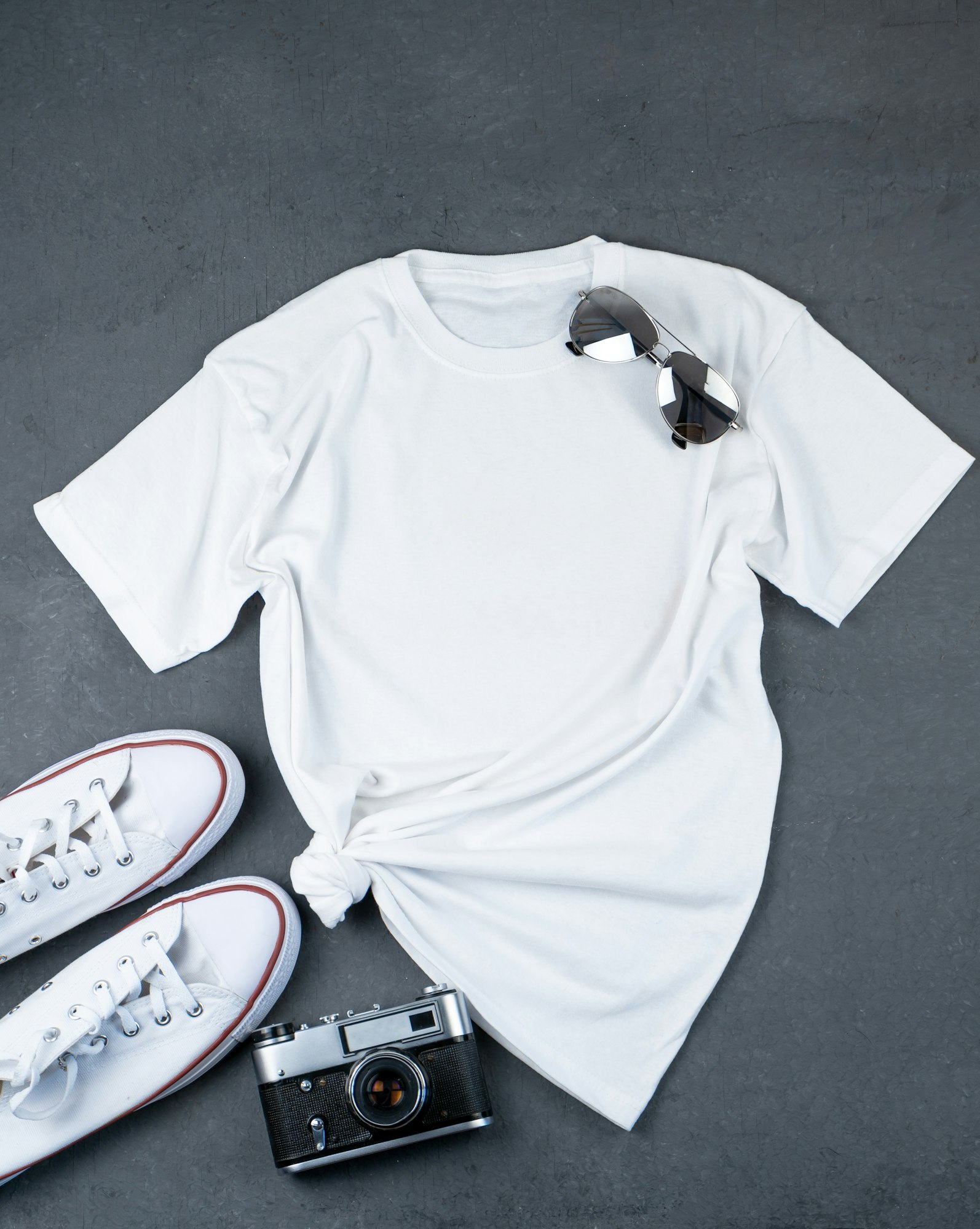 White T-shirt with place for text. Sneakers, glasses, camera - a set of clothes for walking. T-shirt